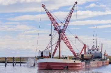 Dredger ship navy working to clean a navigation channel