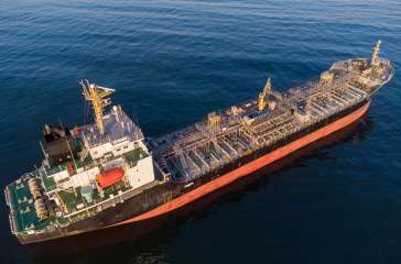 Large general cargo ship tanker bulk carrier, Top down aerial view at sunset.