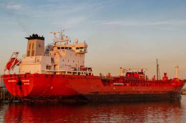 Rotterdam Netherlands June 2020, Oil harbor with chemical carriers in the port of Rotterdam during sunrise in the harbor, huge oil tanks to store gas and oil